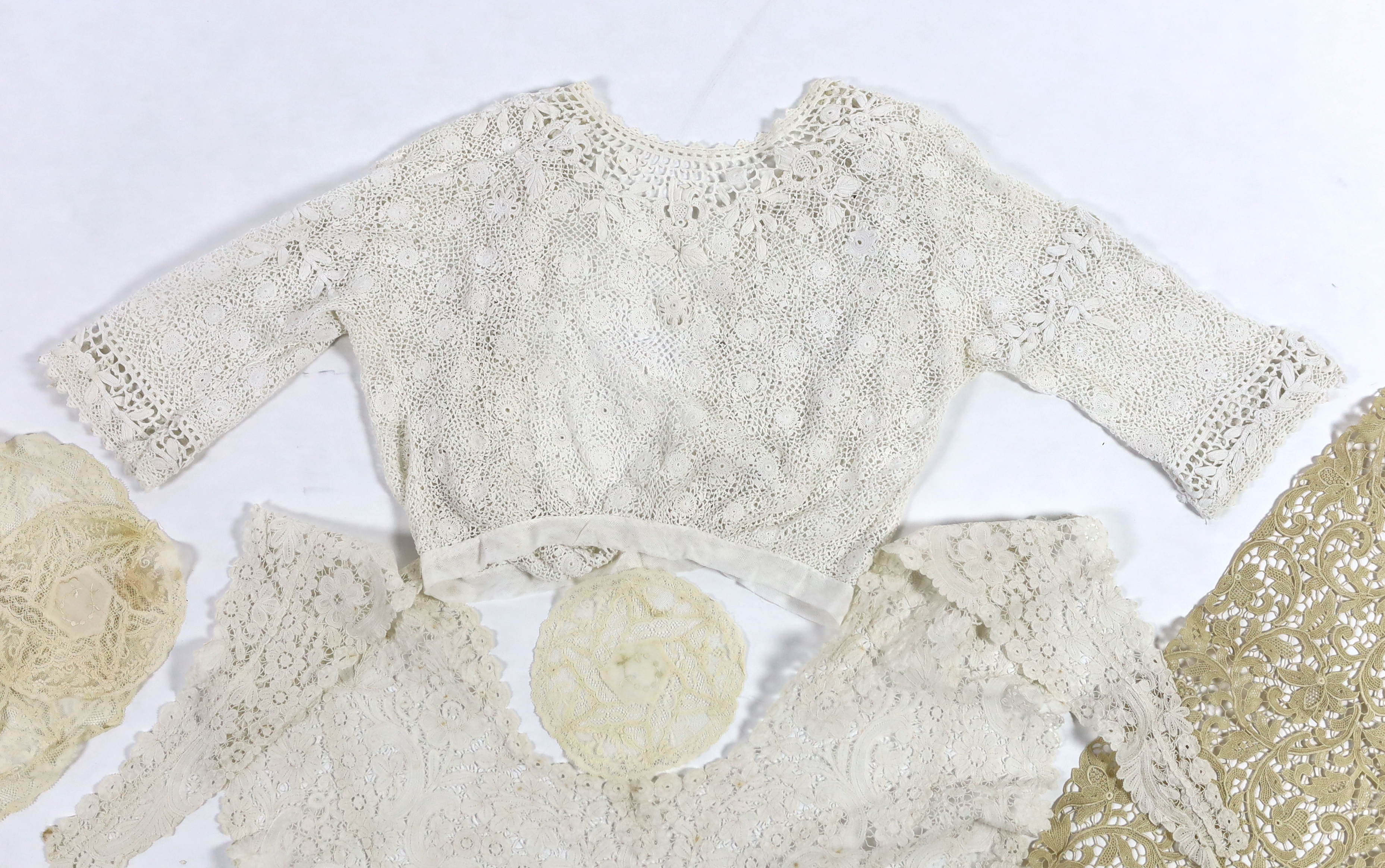 An Edwardian handmade Irish crocheted ladies blouse (small size), a Brussels hand bobbin lace Bertha with Point de Gaze insertions, two large and one small Normandy lace mats, four large and two smaller similar needle la